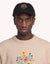 Model trägt die schwarze OLOW Blossom Yourself Cap mit farbiger Blumenstickerei – Vorderansicht